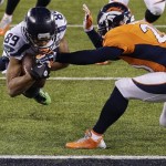 Seattle Seahawks wide receiver Doug Baldwin (89) dives into the end zone for a touchdown against Denver Broncos free safety Mike Adams (20) during the second half of the NFL Super Bowl XLVIII football game Sunday, Feb. 2, 2014, in East Rutherford, N.J. (AP Photo/Gregory Bull)