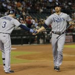 Tampa Bay Rays' Ben Zobrist is greeted by teammate Evan Longoria (3) after scoring on a base hit by Matt Joyce against the Arizona Diamondbacks during the first inning of a baseball game on Wednesday, Aug. 7, 2013, in Phoenix. (AP Photo/Matt York)