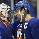 New York Islanders goalie Evgeni Nabokov, left, of Kazakhstan, and center John Tavares (91) celebrate after the Islanders defeated the Coyotes 6-1 in an NHL hockey game at Nassau Coliseum in Uniondale, N.Y., Tuesday, Oct. 8, 2013. (AP Photo/Kathy Willens)