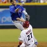 Chicago Cubs' Starlin Castro forces out Arizona Diamondbacks' Wil Nieves (27) during the sixth inning of a baseball game while trying to turn a double play, Thursday, July 25, 2013, in Phoenix. Cliff Pennington was safe at first. (AP Photo/Matt York)