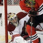  Phoenix Coyotes goalie Mike Smith, left, blocks a shot by Chicago Blackhawks' Andrew Shaw during the second period of an NHL hockey game in Chicago, Thursday, Nov. 14, 2013. (AP Photo/Nam Y. Huh)