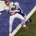 Kansas City Chiefs wide receiver Dwayne Bowe (82) scores a touchdown as Indianapolis Colts free safety Darius Butler (20) defends during the first half of an NFL wild-card playoff football game Saturday, Jan. 4, 2014, in Indianapolis. (AP Photo/AJ Mast)
