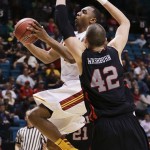 USC's Byron Wesley, left, shoots against Utah's Jason Washburn in the second half during a Pac-12 tournament NCAA college basketball game on Wednesday, March 13, 2013, in Las Vegas. Utah won 69-66. (AP Photo/Julie Jacobson)