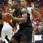 Long Beach State's Dan Jennings, in front, maneuvers against the defense of Arizona's Brandon Ashley, in back, in the second half of an NCAA of an college basketball game, Monday, Nov. 11, 2013 in Tucson, Ariz. (AP Photo/John Miller)