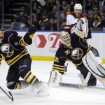  Buffalo Sabres' Tyler Ennis (63) and Ryan Miller (30) each get a glove up as Phoenix Coyotes' Mike Ribeiro (63) watches the rebound during the second period of an NHL hockey game in Buffalo, N.Y., Monday, Dec. 23, 2013. (AP Photo/Gary Wiepert)