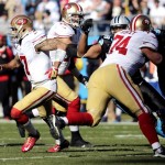  San Francisco 49ers quarterback Colin Kaepernick (7) moves out of the pocket against the Carolina Panthers during the first half of a divisional playoff NFL football game, Sunday, Jan. 12, 2014, in Charlotte, N.C. (AP Photo/Chuck Burton)