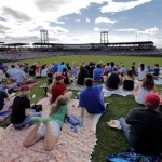 Fans watch from the right-field lawn seats as the Arizona Diamondbacks and Chicago Cubs compete during the fourth inning of a spring training baseball game, Thursday, Feb. 27, 2014, in Mesa, Ariz. (AP Photo/Matt York)