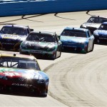 Kyle Busch (18) leads a group of cars out of the third turn during the NASCAR Sprint Cup Series auto race at Phoenix International Raceway, Sunday, Nov. 11, 2012, in Avondale, Ariz. (AP Photo/Ross D. Franklin)