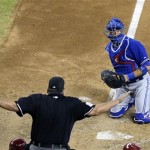 Toronto Blue Jays' J.P. Arencibia, right, looks at umpire Hunter Wendelstedt, who signals that Arizona Diamondbacks' Tony Campana was safe sliding into home plate to score a run in the seventh inning of a baseball game, Wednesday, Sept. 4, 2013, in Phoenix. (AP Photo/Ross D. Franklin)