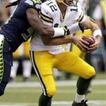Seattle Seahawks defensive end Bruce Irvin, left, sacks Green Bay Packers quarterback Aaron Rodgers (12) in the first half of an NFL football game, Monday, Sept. 24, 2012, in Seattle. (AP Photo/Ted S. Warren)