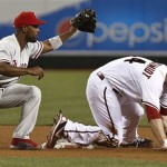Philadelphia Phillies' Jimmy Rollins, left, tags out Arizona Diamondbacks' Paul Goldschmidt trying to steal second base during the fourth inning of a baseball game on Thursday, May 9, 2013, in Phoenix. (AP Photo/Ross D. Franklin)