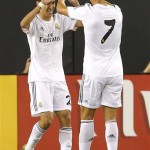 Real Madrid forward Cristiano Ronaldo (7) high-fives Angel DiMaria after DiMaria scored a goal against the Los Angeles Galaxy during the first half of the International Champions Cup soccer match, Thursday, Aug. 1, 2013, in Glendale, Ariz. (AP Photo/Matt York)