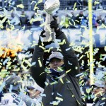 Seattle Seahawks owner Paul Allen lifts the Vince Lombardi Trophy during a rally on Wednesday, Feb. 5, 2014, in Seattle. The Seahawks defeated the Denver Broncos on Sunday in NFL football's Super Bowl XLVIII game in East Rutherford, N.J. (AP Photo/Ted S. Warren)