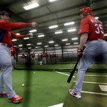 St. Louis Cardinals manager Mike Matheny, left, talks to starting pitcher Jake Westbrook (35) during bunting drills in the indoor batting cage at spring training baseball, Thursday, Feb. 14, 2013, in Jupiter, Fla. (AP Photo/Julio Cortez)