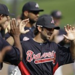 Atlanta Braves second baseman Blake DeWitt stretches with teammates before a baseball spring training exhibition game against the Detroit Tigers, Wednesday, Feb. 27, 2013, in Lakeland, Fla. (AP Photo/Charlie Neibergall)