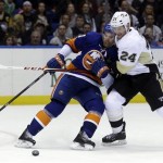 Pittsburgh Penguins' Matt Cooke, right, takes down New York Islanders' John Tavares during the third period of Game 3 of an NHL hockey Stanley Cup first-round playoff series on Sunday, May 5, 2013, in Uniondale, N.Y. (AP Photo/Seth Wenig
