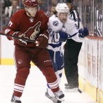 Phoenix Coyotes right winger Radim Vrbata, left, of the Czech Republic, checks Tampa Bay Lightning center Steven Stamkos, right, off the puck in the first period of an NHL hockey game on Saturday, Jan. 21, 2012, in Glendale, Ariz. (AP Photo/Paul Connors)