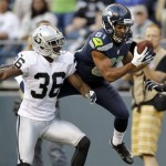  Seattle Seahawks' Golden Tate, right, catches the ball in front of Oakland Raiders' Shawntae Spencer in the first half of a preseason NFL football game, Thursday, Aug. 30, 2012, in Seattle. (AP Photo/Stephen Brashear)