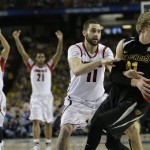 Wichita State's Ron Baker (31) and Louisville's Luke Hancock move during the second half of the NCAA Final Four tournament college basketball semifinal game Saturday, April 6, 2013, in Atlanta. Louisville won 72-68. (AP Photo/David J. Phillip)
