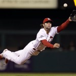 St. Louis Cardinals shortstop Pete Kozma makes a diving catch of a ball hit by Pittsburgh Pirates' Neil Walker in the fourth inning of Game 5 of a National League baseball division series on Wednesday, Oct. 9, 2013, in St. Louis. (AP Photo/Jeff Roberson)