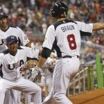 U.S.A.'s Ryan Braun (8) is congratulated by Shane Victorino (50) after Braun scored a run against Puerto Rico during the first inning of a second round World Baseball Classic game, Tuesday, March 12, 2013 in Miami. The United States defeated Puerto Rico 7-1. (AP Photo /Mike Ehrmann,Pool)