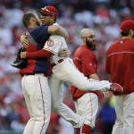 St. Louis Cardinals' Jon Jay leaps in the arms of teammate Chris Carpenter after Game 2 of the National League baseball championship series against the Los Angeles Dodgers Saturday, Oct. 12, 2013, in St. Louis. Cardinals won 1-0 to take a 2-0 lead in the series. (AP Photo/Jeff Roberson)