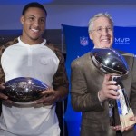 Seattle Seahawks head coach Pete Carroll, right, poses for a photograph with the Vince Lombardi trophy alongside Super Bowl XLVIII MVP Malcolm Smith, during a news conference at the Super Bowl Media Center at the Sheraton hotel, Monday, Feb. 3, 2014, in New York. The Seattle Seahawks defeated the Denver Broncos, 43-8. (AP Photo/John Minchillo)
