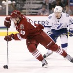 Phoenix Coyotes right winger Mikkel Boedker, left, of Denmark, circles away from Tampa Bay Lightning center Dana Tyrell, right, as Boedker carries the puck into the Lightning zone in the first period of an NHL hockey game on Saturday, Jan. 21, 2012, in Glendale, Ariz. (AP Photo/Paul Connors)
