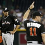 Miami Marlins' Jose Fernandez, left, looks on as manager Mike Redmond (11) calls for a new pitcher during the eighth inning of a baseball game against the Arizona Diamondbacks, Wednesday, June 19, 2013, in Phoenix. The Diamondbacks defeated the Marlins 3-1. (AP Photo/Ross D. Franklin)