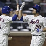 New York Mets' Anthony Recker (20) celebrates with teammate Omar Quintanilla (3) after hitting a home run during the fifth inning of a baseball game Tuesday, July 2, 2013, in New York. (AP Photo/Frank Franklin II)