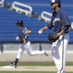 Milwaukee Brewers starter Yovani Gallardo watches as Logan Schafer rounds the bases after hitting a home run during an intrasquad game at spring training baseball Friday, Feb. 22, 2013, in Phoenix. (AP Photo/Morry Gash)