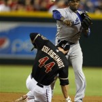 Los Angeles Dodgers shortstop Hanley Ramirez (13), right, turns the double play while avoiding Arizona Diamondbacks' Paul Goldschmidt (44) in the fourth inning during a baseball game on Monday, July 8, 2013, in Phoenix. (AP Photo/Rick Scuteri)