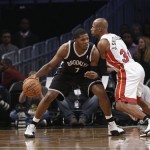 Brooklyn Nets' Joe Johnson (7) is defended by Miami Heat's Ray Allen (34) during the first half of an NBA basketball game on Friday, Jan. 10, 2014, in New York. (AP Photo/Frank Franklin II)