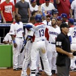 Dominican Republic's Hanley Ramirez is greeted by teammates after his sacrifice fly drove in the tying run against Italy in the seventh inning of their World Baseball Classic game in Miami, Tuesday, March 12, 2013. The Dominican Republic won 5-4. (AP Photo/Alan Diaz)