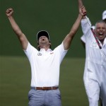 Adam Scott, of Australia, celebrates with caddie Steve Williams after making a birdie putt on the second playoff hole to win the Masters golf tournament Sunday, April 14, 2013, in Augusta, Ga. (AP Photo/David Goldman)
