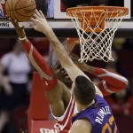  Houston Rockets' Dwight Howard, left, shoots as Phoenix Suns' Miles Plumlee (22) defends during the first quarter of an NBA basketball game Wednesday, Dec. 4, 2013, in Houston. (AP Photo/David J. Phillip)