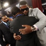 Sharrif Floyd, a defensive tackle from Florida, is hugged in the green room before the first round of the NFL football draft, Thursday, April 25, 2013, at Radio City Music Hall in New York. (AP Photo/Jason DeCrow)