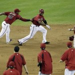Arizona Diamondbacks' Justin Upton, center, is chased down by teammates Juan Miranda (46) and Willie Bloomquist, right, after Upton hit the game winning RBI single to score Bloomquist against the Florida Marlins during the ninth inning of a baseball game, Wednesday, June 1, 2011, in Phoenix. (AP Photo/Matt York)