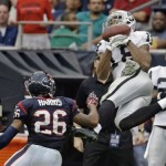 Houston Texans' Brandon Harris (26) breaks up a pass intended for Oakland Raiders' Andre Holmes during the second half of an NFL football game Sunday, Nov. 17, 2013, in Houston. (AP Photo/Morry Gash)