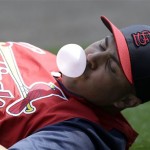 St. Louis Cardinals right fielder Carlos Beltran blows a bubble with chewing gum while stretching before an exhibition spring training baseball game against the New York Mets, Wednesday, Feb. 27, 2013, in Port St. Lucie, Fla. (AP Photo/Julio Cortez)