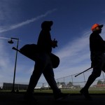 Houston Astros first base coach Dave Clark, right, and second baseman Jose Altuve make their way to the practice fields for a spring training baseball workout Saturday, Feb. 16, 2013, in Kissimmee, Fla. (AP Photo/David J. Phillip)
