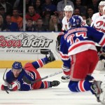 New York Rangers' Ryan Callahan, left, dives to pass the puck to Ryan McDonagh (27) during the first period of Game 1 of a first-round NHL hockey playoff series against the Ottawa Senators, Thursday, April 12, 2012, in New York. (AP Photo/Frank Franklin II)