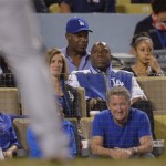  Los Angeles Dodgers owner Magic Johnson, center right, and Actor Dennis Haysbert, second from left on top, watch play during the sixth inning of Game 4 of the National League baseball championship series against the St. Louis Cardinals Tuesday, Oct. 15, 2013, in Los Angeles. (AP Photo/Mark J. Terrill)