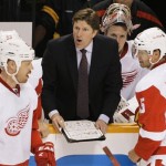Detroit Red Wings head coach Mike Babcock, center, talks with players, including Johan Franzen (93), of Sweden, and Nicklas Lidstrom (5), also of Sweden, in the third period against the Nashville Predators in Game 1 of a first-round NHL hockey playoff series on Wednesday, April 11, 2012, in Nashville, Tenn. The Predators won 3-2. (AP Photo/Mark Humphrey)
