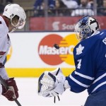  Toronto Maple Leafs goaltender James Reimer makes a save under pressure from Phoenix Coyotes left winger Tim Kennedy (34) during the first period of NHL hockey game action in Toronto on Thursday, Dec. 19, 2013. (AP Photo/The Canadian Press, Frank Gunn)