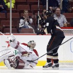 Anaheim Ducks right wing Teemu Selanne, right, skates past Phoenix Coyotes goalie Mark Visentin after scoring during the first period of their preseason NHL hockey game, Monday, Sept. 16, 2013, in Anaheim, Calif. (AP Photo/Mark J. Terrill)