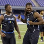 South Carolina defensive lineman Jadeveon Clowney, left, jokes with Florida State defensive lineman Timmy Jernigan during drills at the NFL football scouting combine in Indianapolis, Monday, Feb. 24, 2014. (AP Photo/Michael Conroy)