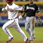 Arizona Diamondbacks' Aaron Hilll rounds the bases after hitting a two-run home run as Miami Marlins' Donovan Solano looks on during the first inning of a baseball game on Wednesday, Aug. 22, 2012, in Phoenix. (AP Photo/Matt York)