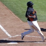 San Francisco Giants' Pablo Sandoval scores on a base hit by teammate Joaquin Arias during the third inning of a spring training baseball game against the Chicago White Sox, Monday, Feb. 25, 2013, in Scottsdale, Ariz. (AP Photo/Matt York)v