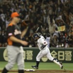 Japan's designated hitter Shinnosuke Abe rounds first base after hitting a solo homer off Netherlands' starter David Bergman, left, in the second inning of their World Baseball Classic second round game at Tokyo Dome in Tokyo, Tuesday, March 12, 2013. (AP Photo/Toru Takahashi)